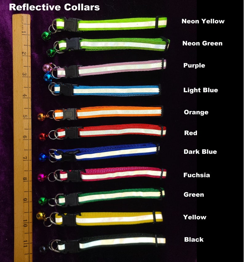 May include: A set of 12 reflective dog collars in various colours, including neon yellow, neon green, purple, light blue, orange, red, dark blue, fuchsia, green, yellow, and black. Each collar has a white reflective strip and a small bell.