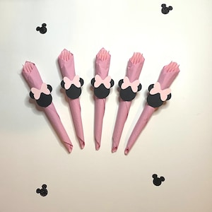 May include: Five pink napkins with black and pink Minnie Mouse head napkin rings.