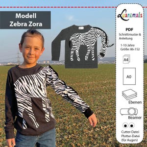 May include: A dark gray long-sleeved shirt with a white zebra print design. The shirt is modeled by a child. The image also includes a smaller image of the shirt and text that reads "Modell Zebra Zora" and "Luanimals".