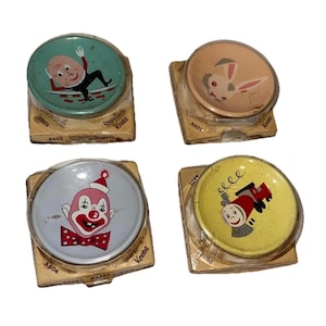 May include: Four vintage Story Book Knobs with colorful illustrations. The knobs feature Humpty Dumpty, a bunny, a clown, and a train. Each knob is packaged in its original cardboard backing.