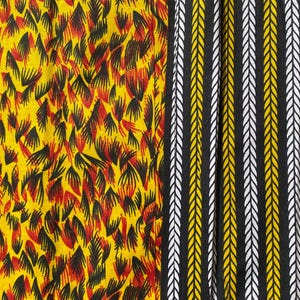 May include: A fabric with a yellow background and a pattern of black and red stylized leaves. The fabric is sewn together with a black fabric with a pattern of white and yellow stylized arrows.