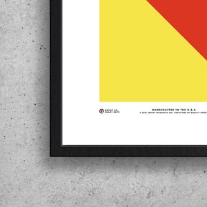 May include: A framed print with a yellow and red geometric design. The print includes the text "QWINT CO. CHART DEPT." and "HANDCRAFTED IN THE U.S.A. &copy; 2021 QWINT RESOURCES INC. PURVEYORS OF QUALITY GOODS".
