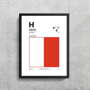 May include: A black and white minimalist poster with the word "HOTEL" in all caps and the word "pronounced: ho-tell" in smaller font below. The poster also features a graphic of a person standing with a flag in their hand. The poster is framed in a black frame.