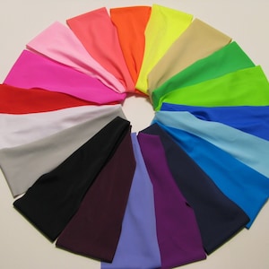May include: A set of 18 colorful headbands in a variety of colors, including pink, red, orange, yellow, green, blue, purple, and black.