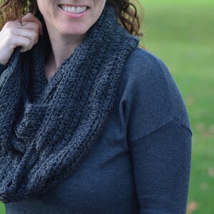 Close-up of a woman wearing a crocheted infinity scarf.