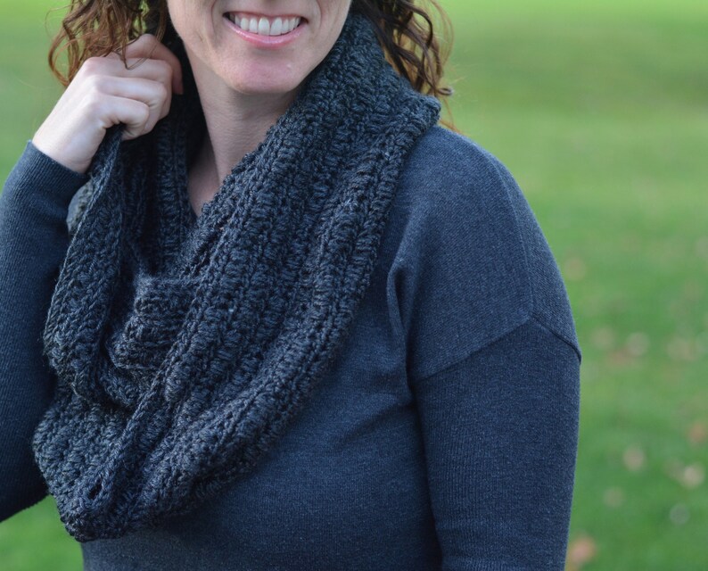 Close-up of a woman wearing a crocheted infinity scarf.