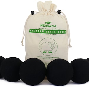 May include: Six black wool dryer balls in a white cotton drawstring bag with the text "NERVANA All Natural, Organic, Eco-Friendly PREMIUM DRYER BALLS Hand-made in Nepal 100% Merino Wool from New Zealand A Fair Trade Product" printed on the bag.