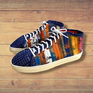 May include: A pair of high-top trainers featuring a quilted, multi-coloured fabric upper with vertical stripes in shades of orange, blue, and white. The shoes have white laces, orange eyelets, and a solid white rubber sole with a textured toe cap.