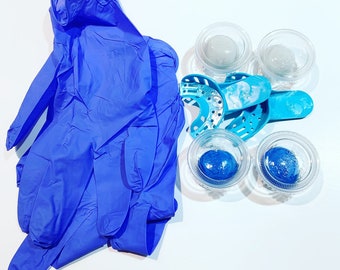 May include: Blue disposable gloves, blue and white trays with clear lids, and blue plastic dental impression trays.