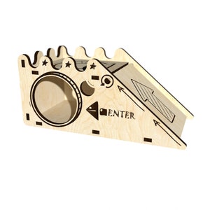 Puede incluir: Juguete de madera con un túnel y una rampa. La rampa tiene una flecha negra apuntando hacia arriba y el texto "ENTER" en el lateral. El túnel tiene tres estrellas encima.