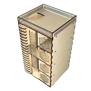 Puede incluir: Un organizador de madera con múltiples compartimentos y estantes. El organizador está hecho de madera clara y tiene un acabado natural. Tiene un pequeño balcón en la parte superior.