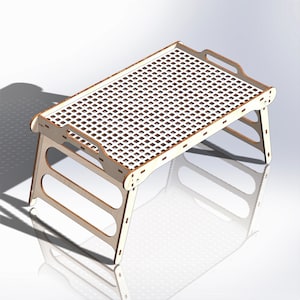 May include: A wooden folding table with a white grid pattern top. The table has a handle on the top and is made of light wood.