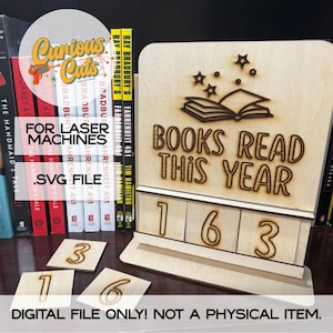 May include: Wooden "Books Read This Year" counter with laser-cut design. Includes numbers 1, 6, and 3, plus additional number tiles. Features an open book and stars graphic. Text: "For Laser Machines .SVG File" and "Digital File Only! Not a Physical Item."