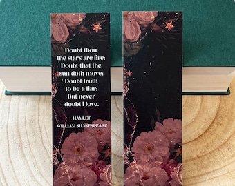 May include: A bookmark with a floral design and a quote from Hamlet by William Shakespeare. The quote reads: "Doubt thou the stars are fire: Doubt that the sun doth move: Doubt truth to be a liar: But never doubt I love." The bookmark is printed on black cardstock with gold glitter accents.