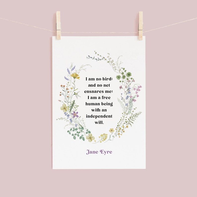 May include: A white card with a floral wreath border and a quote from Jane Eyre: "I am no bird: and no net ensnares me; I am a free human being with an independent will."