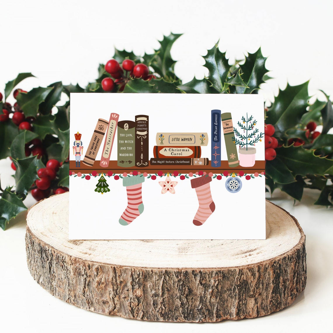 Festive Bookshelf Christmas Cards made by QuoteandQuillShop, a card is on top of a thin log piece with mistletoe in the background.