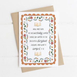 May include: A greeting card with a white background and a decorative orange border. The card features floral and leaf designs, with text that reads "NOW AND THEN, IN THIS WORKADAY WORLD..." The card is placed on a brown envelope.