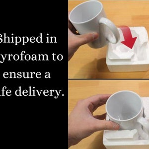 May include: A plain white ceramic mug being placed into a custom-fitted white styrofoam protective packaging block. The mug features a standard handle and a smooth, glossy finish, designed to fit securely within the molded foam insert.