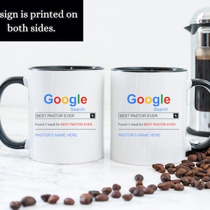 May include: Two white ceramic mugs with black handles and rims. The mugs feature a Google search bar graphic with the text BEST PASTOR EVER, the phrase Found 1 result for BEST PASTOR EVER, and a placeholder line for PASTOR'S NAME HERE.