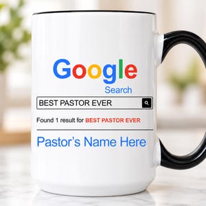 May include: A white ceramic mug with a black handle and rim featuring a Google Search bar graphic. The text reads BEST PASTOR EVER in the search field, followed by Found 1 result for BEST PASTOR EVER and the placeholder text Pastor's Name Here.