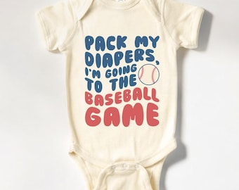 May include: A cream-colored baby onesie with a blue and red graphic that says "Pack my diapers, I'm going to the baseball game". A baseball graphic is included in the text.