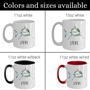 May include: Four white ceramic mugs with a shark graphic and the name "STEVE" printed on them. The mugs are available in three sizes: 11 oz white, 11 oz white with black interior, and 11 oz white with red interior. The largest mug is 15 oz white.