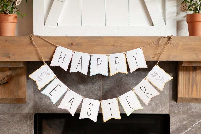 May include: A white banner with scalloped edges hangs above a fireplace. The banner reads "Happy Easter" with a bunny illustration on each end.