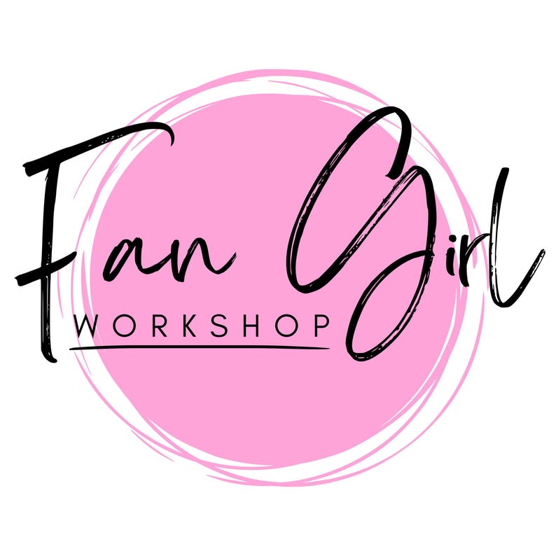 May include: A logo featuring the words "Fan Girl Workshop" in black script. The text is set against a pink circle with a white, textured outline. The background is white.