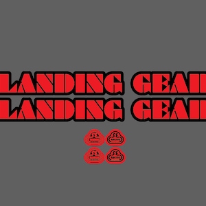 May include: Two red and black stickers with the text "Landing Gear" and two red stickers with the text "SE Racing" in a cloud shape.