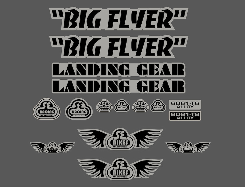 May include: Black and white bicycle decals with the text "BIG FLYER", "LANDING GEAR", and "SE RACING". The decals also include the text "6061-T6 ALLOY" and a logo with wings that says "SE BIKES".