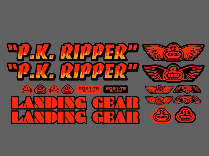 May include: A set of red and black bicycle decals with the text "P.K. RIPPER" and "LANDING GEAR". The decals also feature a logo with the text "SE BIKES" and wings.