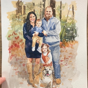 May include: Watercolor portrait of a family of four and a dog. The family is standing in front of a blurred background of trees and foliage. The portrait is painted in soft, warm colors, with the family members wearing casual clothing. The dog is a bulldog.