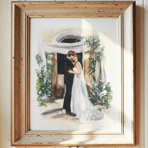 May include: Watercolor painting of a couple embracing, framed in a rustic wooden frame. The artwork depicts a bride in a white gown and a groom in a black suit, surrounded by greenery. A white bow hangs below the frame.