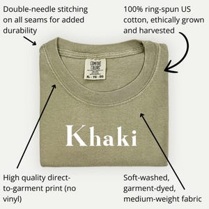 May include: Khaki-colored t-shirt with the word "Khaki" printed on the front. Features include double-needle stitching, 100% ring-spun US cotton, and a soft-washed, garment-dyed, medium-weight fabric. The shirt is ethically grown and harvested.