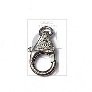 May include: Silver-toned lobster clasp with a clear crystal design. Gemco Jewellery.