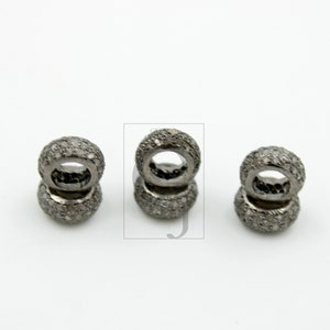 May include: Three silver-toned rings with a pave diamond setting. Each ring is stacked on top of another ring.
