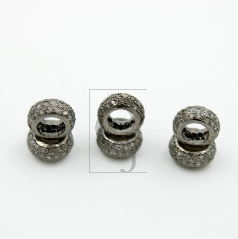 May include: Three silver-toned rings with a pave diamond setting. Each ring is stacked on top of another ring.