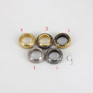 May include: Five silver and gold rings with a pave setting of small diamonds. The rings are numbered 1 through 5.