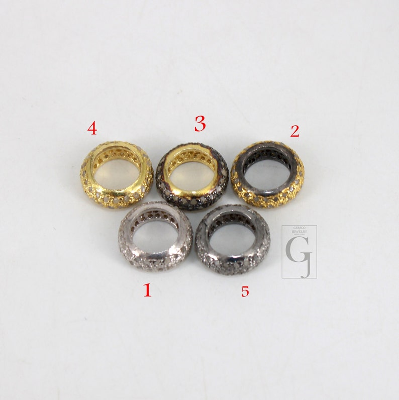 May include: Five silver and gold rings with a pave setting of small diamonds. The rings are numbered 1 through 5.