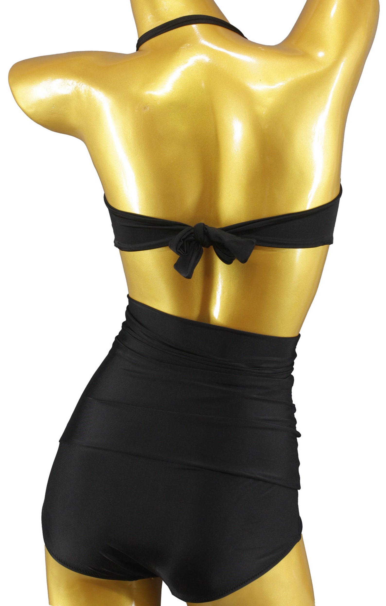Back view of black vintage-style bikini with ruched high-waisted bottoms and halter bandeau top tied in a bow.