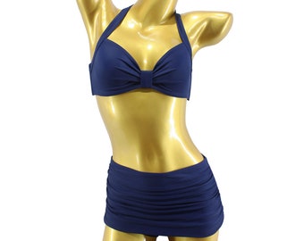May include: A navy blue halter bikini top with a bow detail and matching high-waisted skirt.