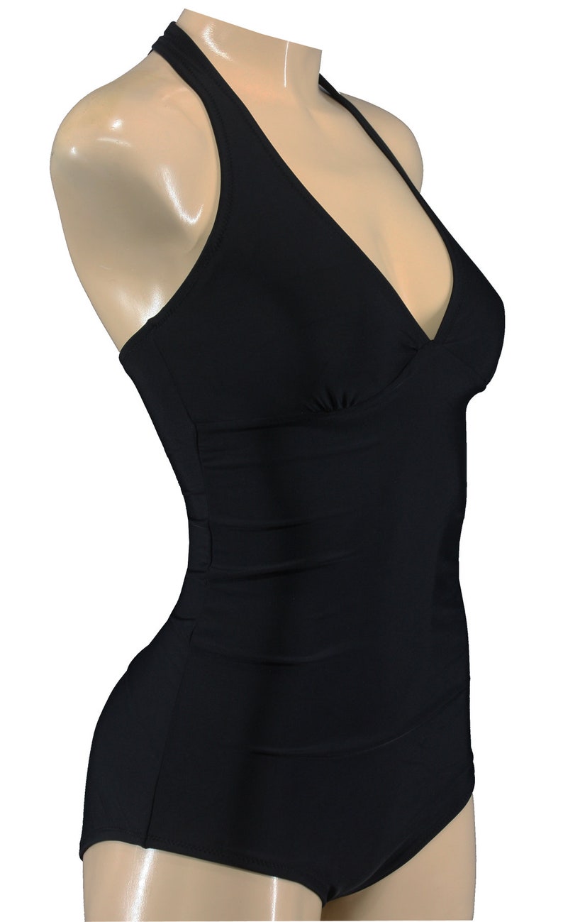 May include: A black halter-style swimsuit with a V-neckline and a high-cut leg.