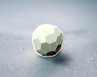 May include: A white and gray geometric sphere with black accents, resting on a light blue surface.