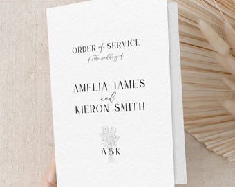 May include: White wedding ceremony order of service booklet with the text "ORDER of SERVICE for the wedding of AMELIA JAMES and KIERON SMITH" and a floral bouquet with the initials "A&K" in the center.
