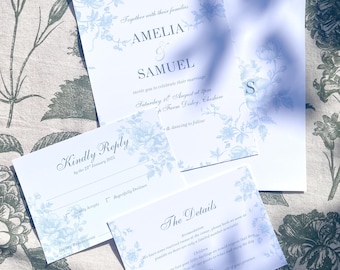 Puede incluir: Un conjunto de invitaciones de boda con un diseño floral azul. La invitación incluye los nombres Amelia y Samuel, la fecha y hora de la boda, y la ubicación. La tarjeta RSVP incluye una sección para que los invitados indiquen su asistencia y sus requisitos dietéticos.