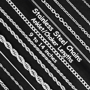 May include: A selection of stainless steel anklet and choker chains, available in lengths from 23 to 36 cm. The image shows various silver chain styles against a black backdrop, highlighting different link patterns.