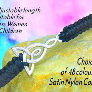 May include: Black braided nylon cord bracelet with a silver Celtic knot charm. The bracelet has an adjustable length. Text on the image says "Choice of 48 colours" and "Satin Nylon Cord".