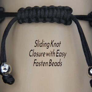 May include: Close-up of a black bracelet with a sliding knot closure and silver-colored beads. The text on the background reads "Sliding Knot Closure with Easy Fasten Beads."