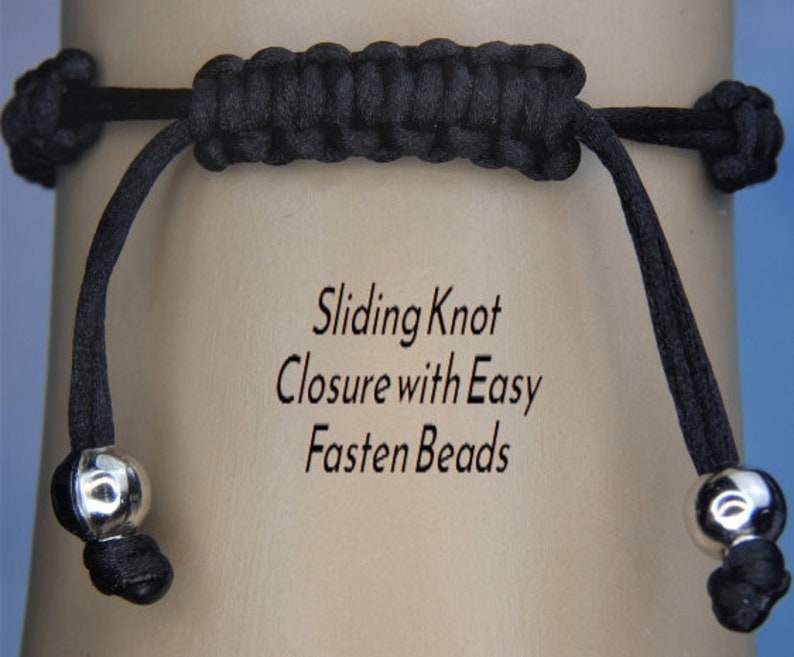 May include: Close-up of a black bracelet with a sliding knot closure and silver-colored beads. The text on the background reads "Sliding Knot Closure with Easy Fasten Beads."