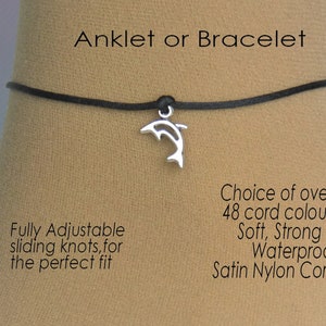 May include: An adjustable black cord anklet or bracelet with a silver dolphin charm. The cord is soft, strong, and waterproof.  Choice of over 48 cord colors.  "Anklet or Bracelet" and "Fully Adjustable sliding knots, for the perfect fit" are written on the image.
